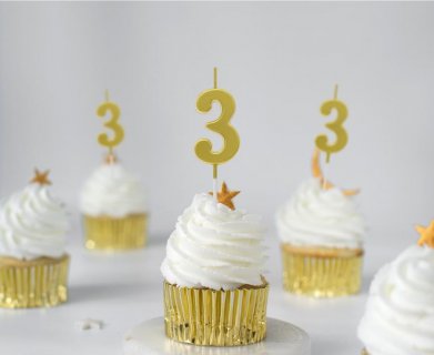 Gold birthday cake candle in the shape of number 3