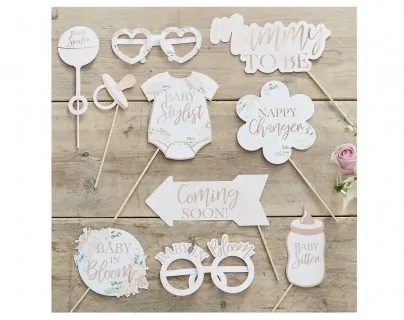 Photo props with floral design and rose gold foiled details for a baby shower theme party
