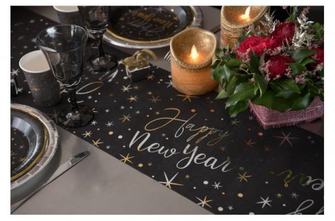 Fabric table runner in black color with gold letters for the New Year's Eve table decoration