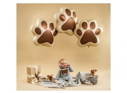 Foil balloon in the shape of a dog paw in brown color for party decoration