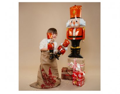 Large foil balloon in the shape of a nutcracker for Christmas.