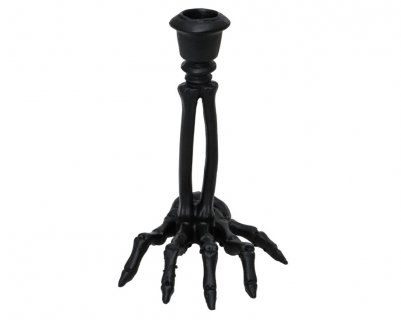 Black candle stick in the shape of skeleton hand