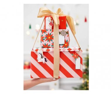Wrapping paper in red color with small gold stars print for gift packaging