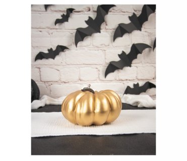 Small gold decorative pumpkin for a Halloween theme party table decoration