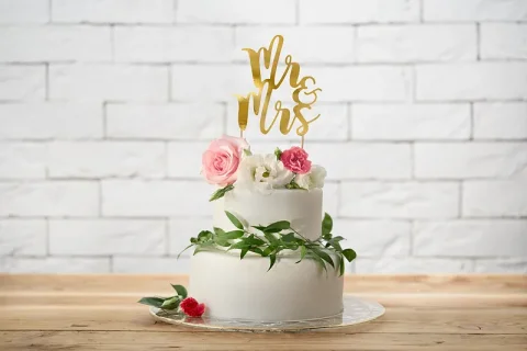 Wedding cake topper with Mr and Mrs letters in gold metallic color
