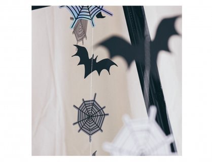Hanging decorations for a Halloween party with bats and spiderwebs