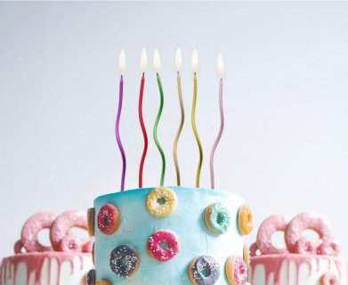 Tall and thin swirl shaped cake candles in various metallic colors