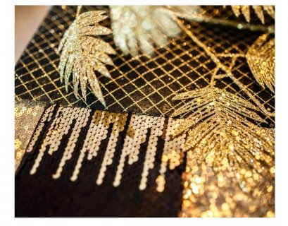 Decorative table runner with reversible sequins in black, gold and silver color