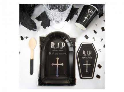 Black paper plates in the shape of a tombstone for a birthday party
