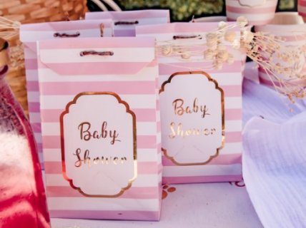 Pink stripes paper treat bags for a baby shower party theme