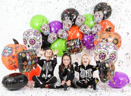 White skull shaped balloon with colorful design for a Halloween theme party