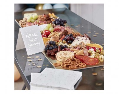 Large serving platter with napkins, table confetti and a tent card