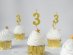 Gold birthday cake candle in the shape of number 3